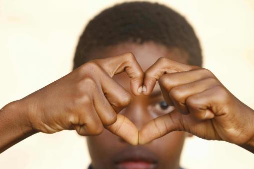 A boy making a heart shape with his fingers. Most policy governing child protection has reflected the heart of a nation, not the head, says a new chapter